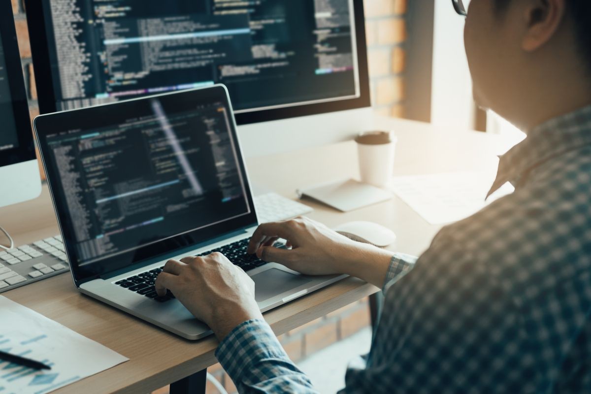 Asian man working development of programming and encryption technology website design programmers on desk in office.